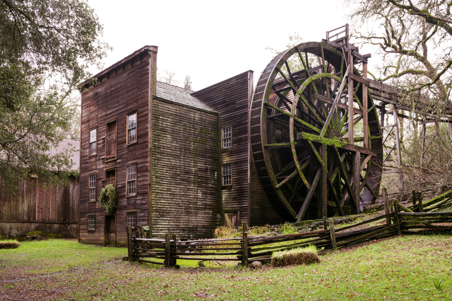 The historic wooden Bale Grist Mill outside of Calistoga, California on an overcast day.
