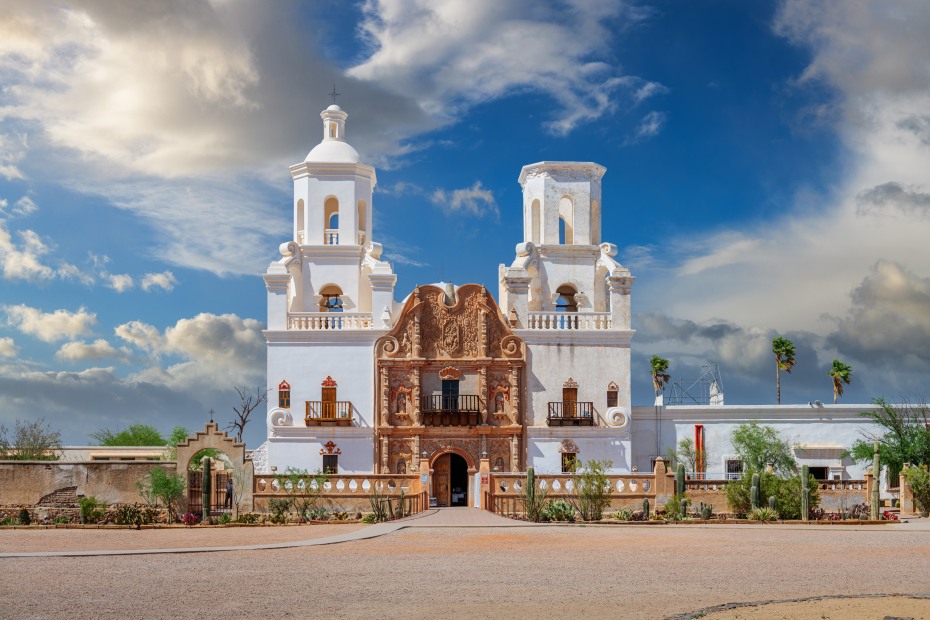 Exterior of historic Mission San Xavier del Bac on a party cloudy day.