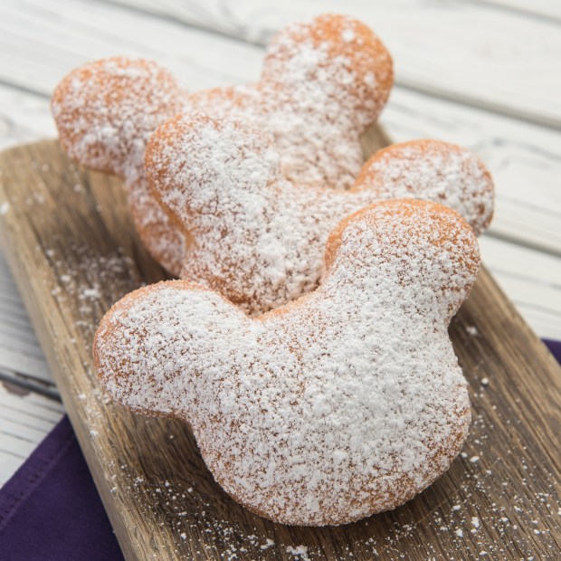 three Mickey Mouse-shaped beignets with a dusting of powdered sugar from the Royal Veranda in Disneyland.