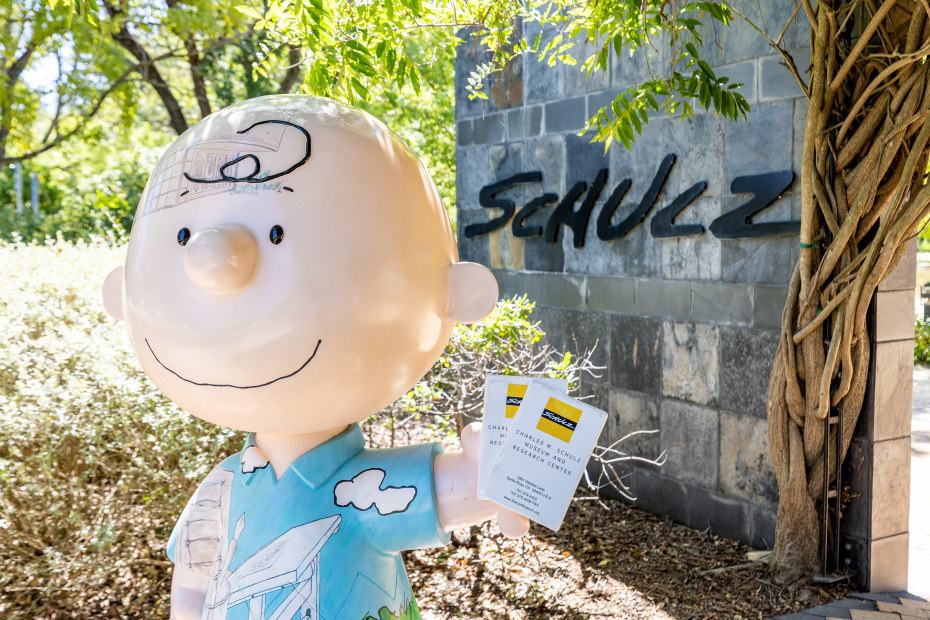 A statue of Charlie Brown holding tickets outside the Charles Schulz museum.