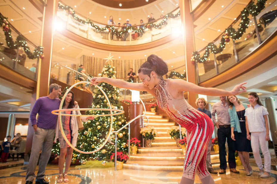 Guests watch a performer aboard a Celebrity Cruises during the holidays.