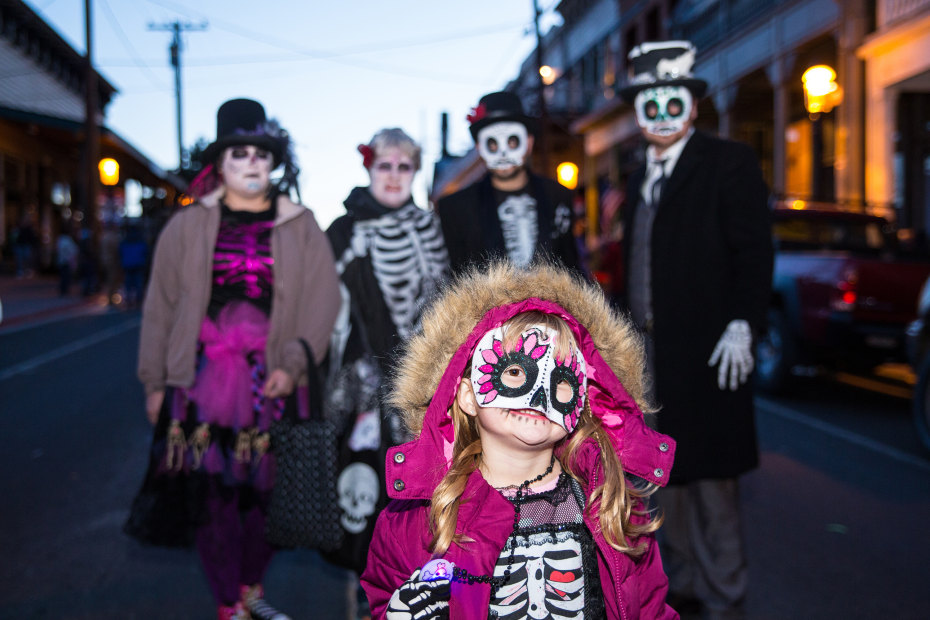 A family dressed up as skeletons walk in the Halloween parade in Virginia City, Nevada.