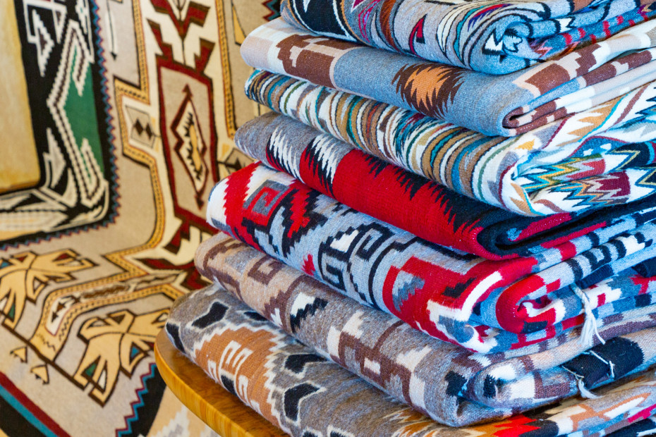A stack of rugs made by Navajo weavers inside the Nizhoni Ranch Gallery.