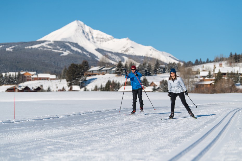 Two people cross-country ski at Big Sky Resort in Montana.