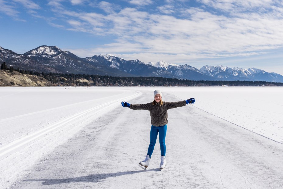 A girl ice skates on the Lake Windermere Whiteway in British Columbia, Canada.