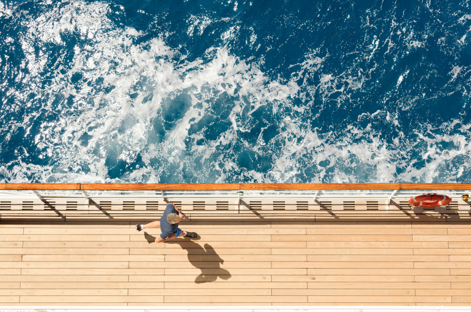 A man runs on the Promenade Deck on Cunard's Queen Mary 2.