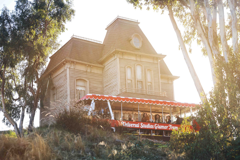 Guests ride past the house from the movie Psycho as part of Universal Studios Hollywood's studio tour.