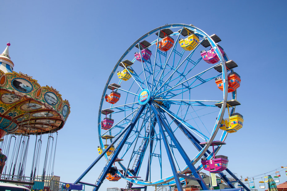 The new Dream Wheel at Santa Cruz Beach Boardwalk on a clear blue day.