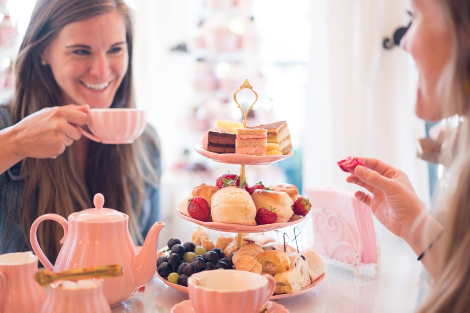 Two people sip tea and eat baked goods at Sugar Mouse Cupcake House in Laramie, Wyoming.