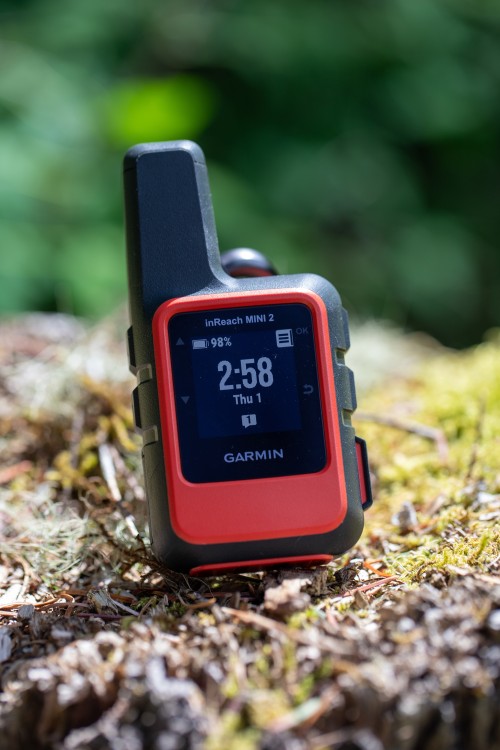 A Garmin InReach MINI 2 on a stump.