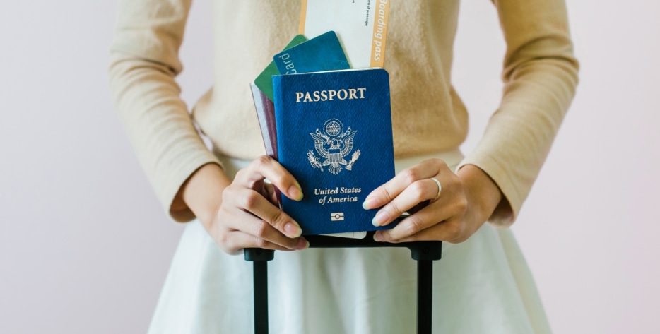 Someone with a passport gets ready to board a plane