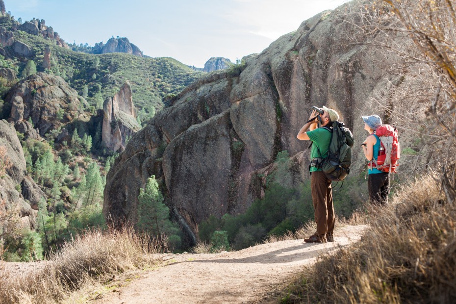 Two hikers look for California condors above Pinnacles National Park.