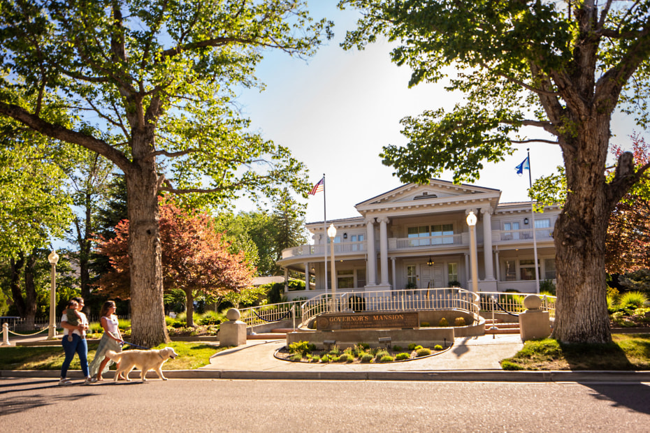 A family walk past the Govenor's Mansion in Carson City, Nevada.