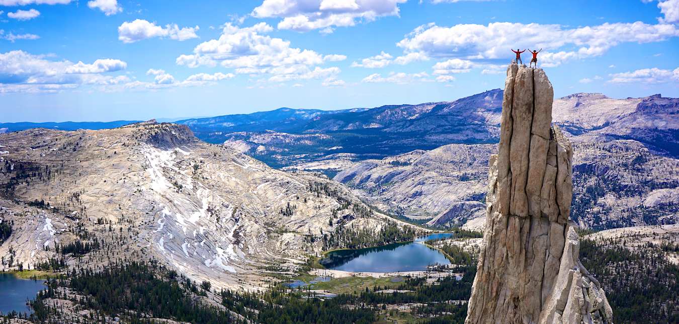 Eichorn Pinnacle with rejoicing rock climbers above Yosemite Valley at Yosemite National Park in California.