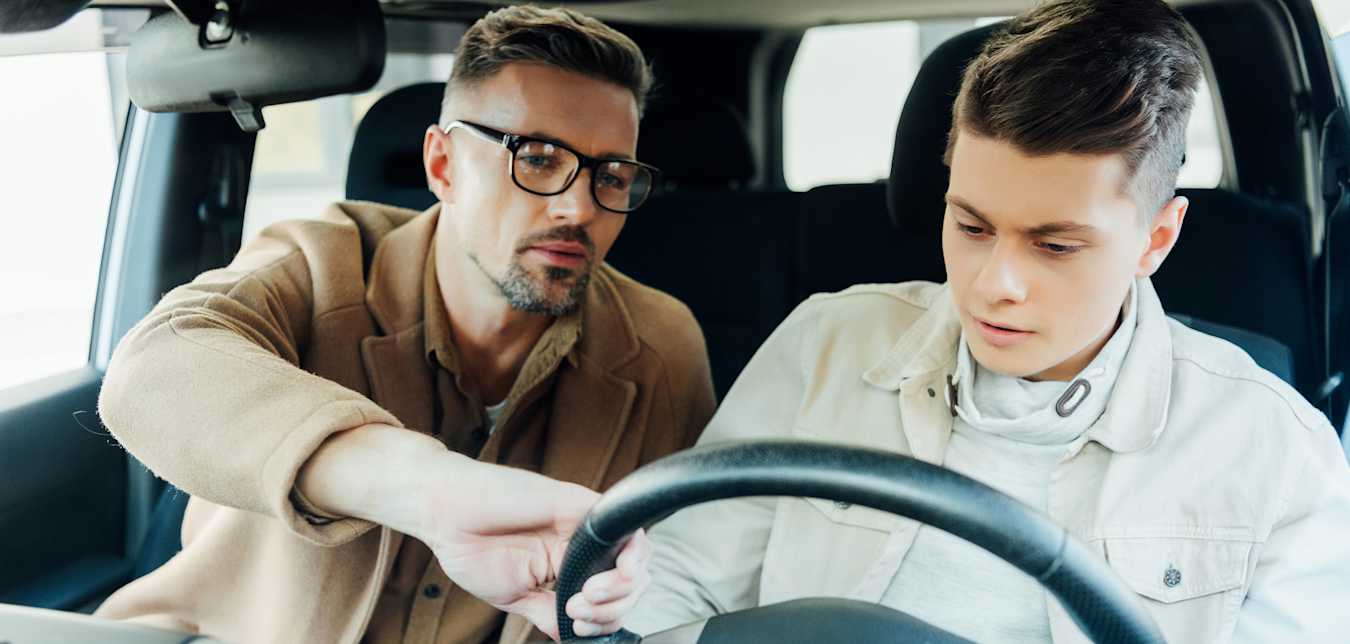 A dad and his teen son shop for a car.