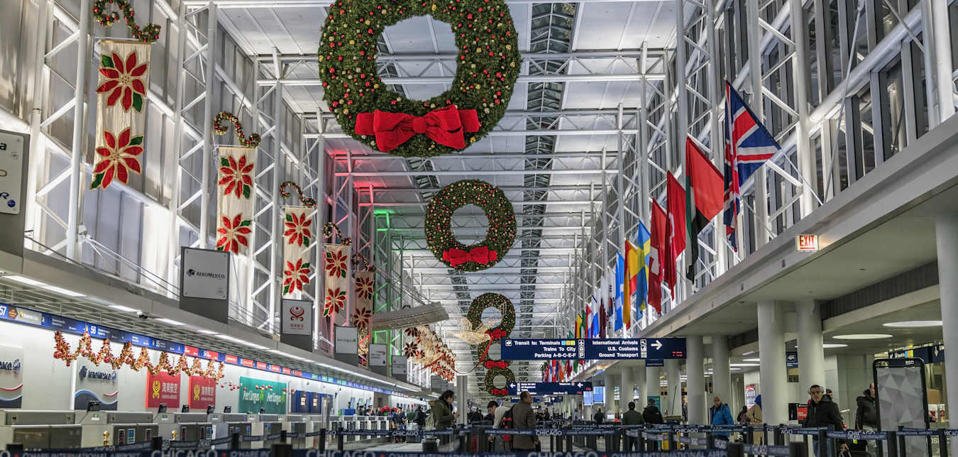 Picture of an airport terminal with passengers in line.