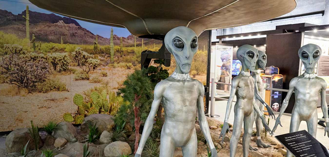 Extra-terrestrial figures near a simulated flying saucer at the International UFO Museum & Research Center in Roswell.