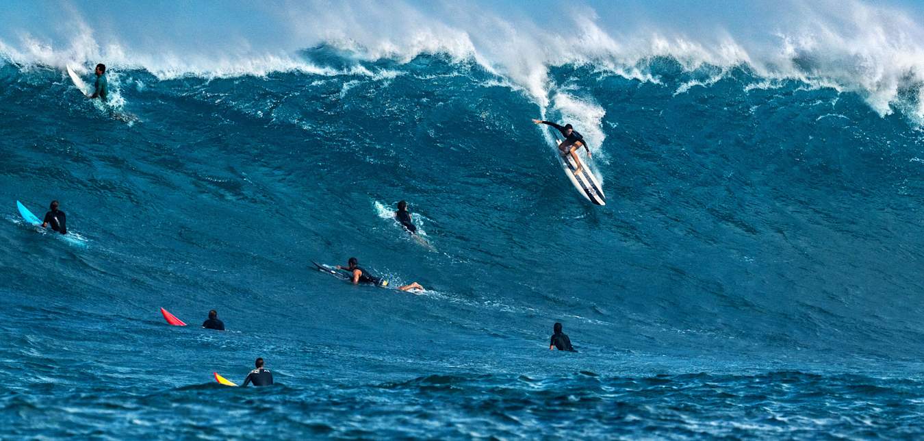 A surfer rides a big wave