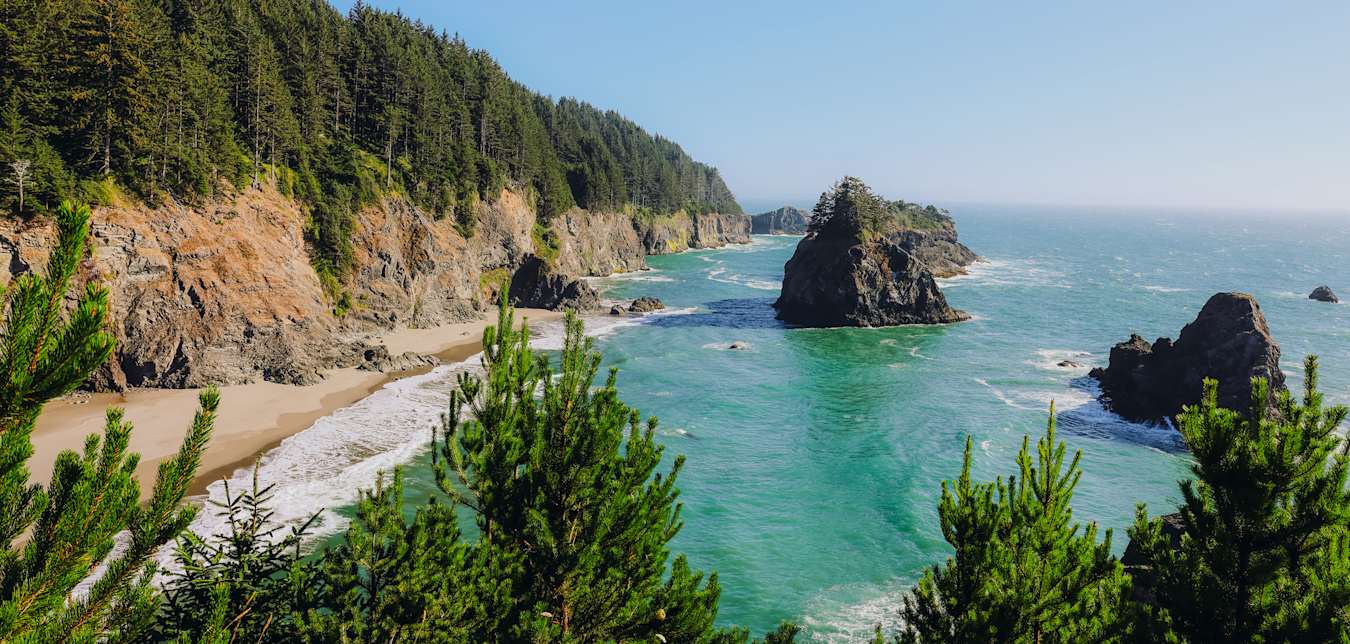 The Pacific Ocean crashes on the beach at Sue-meg State Park in California on a sunny day.