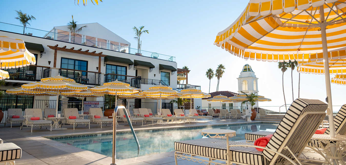 Chairs line the edge of the pool deck at La Bahia Hotel & Spa.