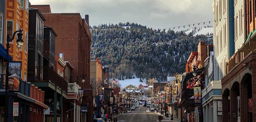 Main Street in Park City, Utah, looking towards the mountains with clouds in the sky