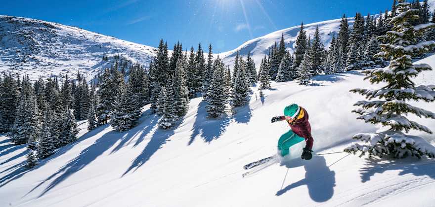 A woman skis down a run at Winter Park Resort in Colorado, photo