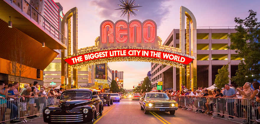 Classic cars drive beneath the famous "The Biggest Little City in the World" sign in Reno, Nevada, photo