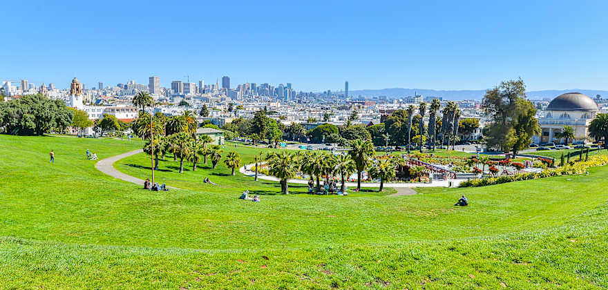 People relax in Mission Dolores Park on a sunny day, image