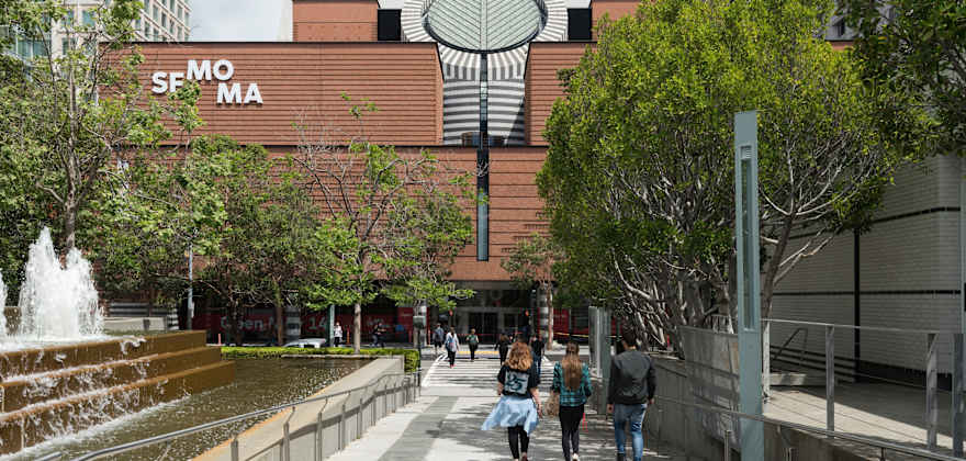 a group friends walks into the Yerba Buena Center entrance of SFMOMA