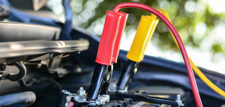 car battery with jumper cables attached