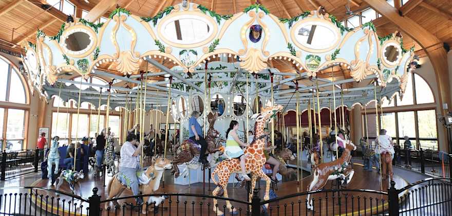 hand-carved wooden animals with riders, both young and old, at the Historic Carousel & Museum in Albany, Oregon, picture