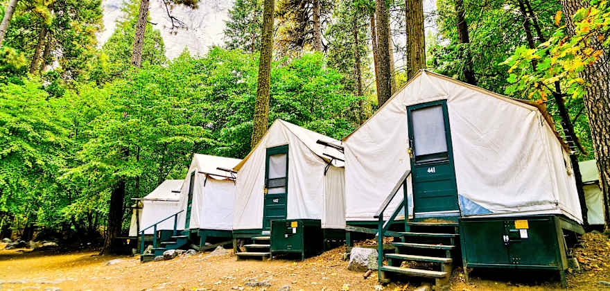 Metal bear-proof food lockers outside canvas tent cabins in Yosemite National Park's Half Dome Village