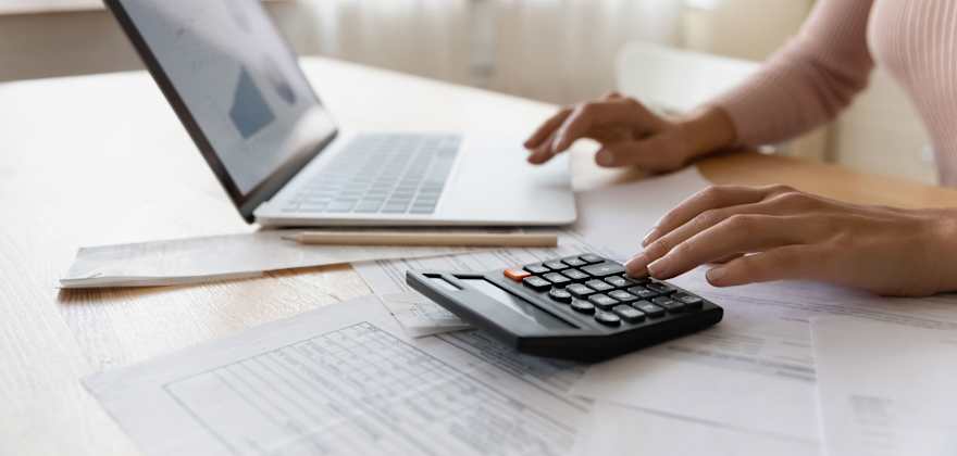 A woman reviews her credit report on her computer.