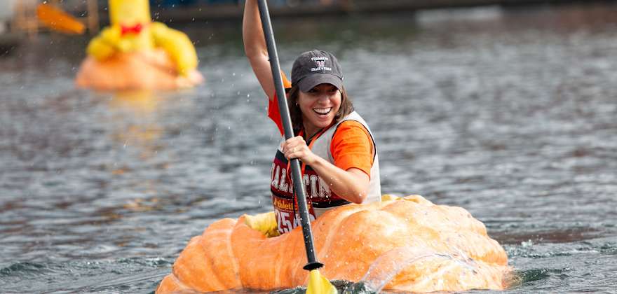 A paddler races to the finish in the West Coast Giant Pumpkin Regatta in Tualatin, Oregon.