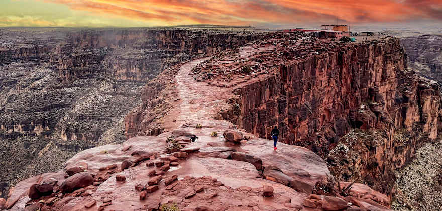 a stunning red and orange sunset over the grand canyon