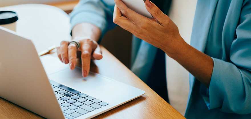 A woman uses two-factor authentication with her phone and her computer.