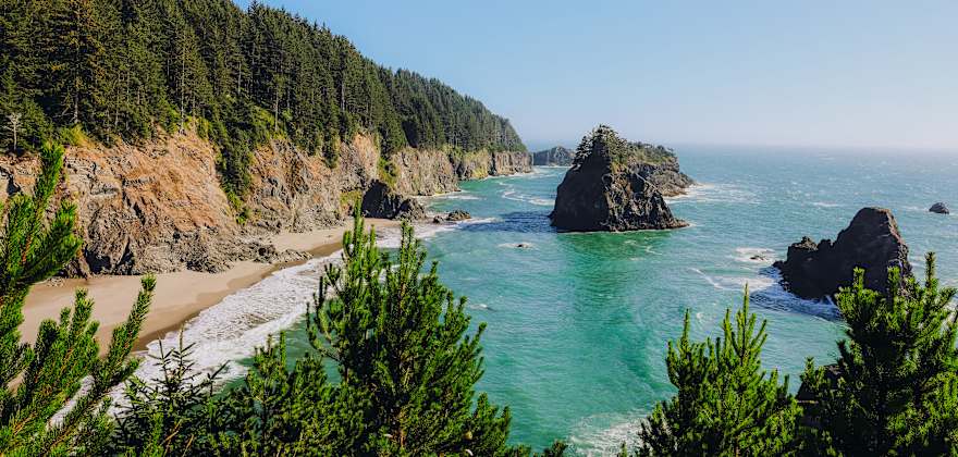 The Pacific Ocean crashes on the beach at Sue-meg State Park in California on a sunny day.