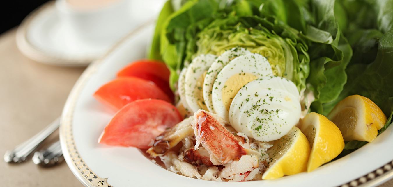 crab Louie salad with lump crab meat, tomato, lettuce, hardboiled egg, and lemon wedges at Palm Court Grill at The Historic Davenport Hotel in Spokane, Washington