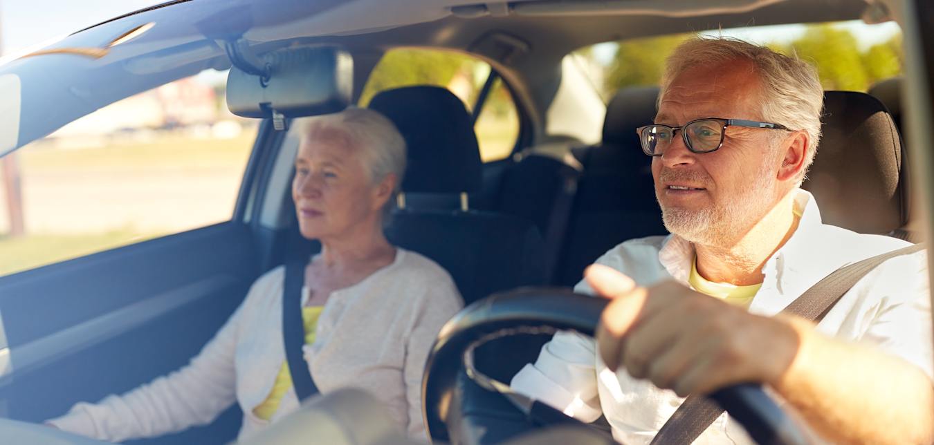 Two seniors in a sedan.