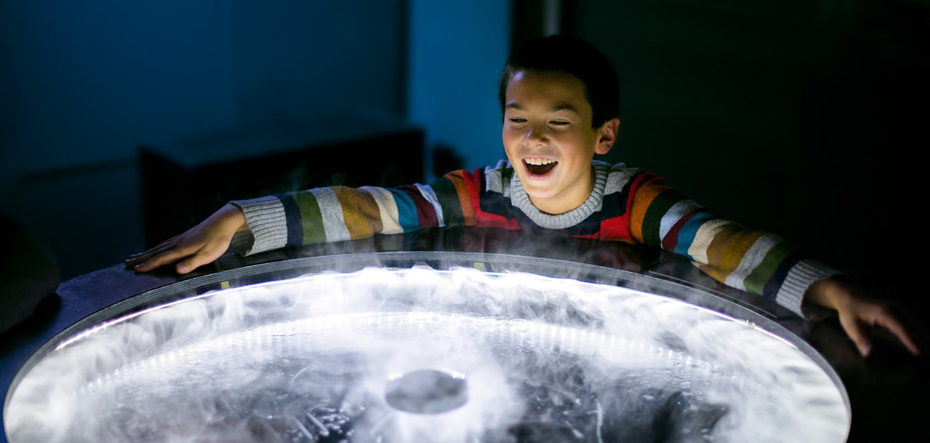 A boy plays with an exhibit at the Exploratorium in San Francisco.