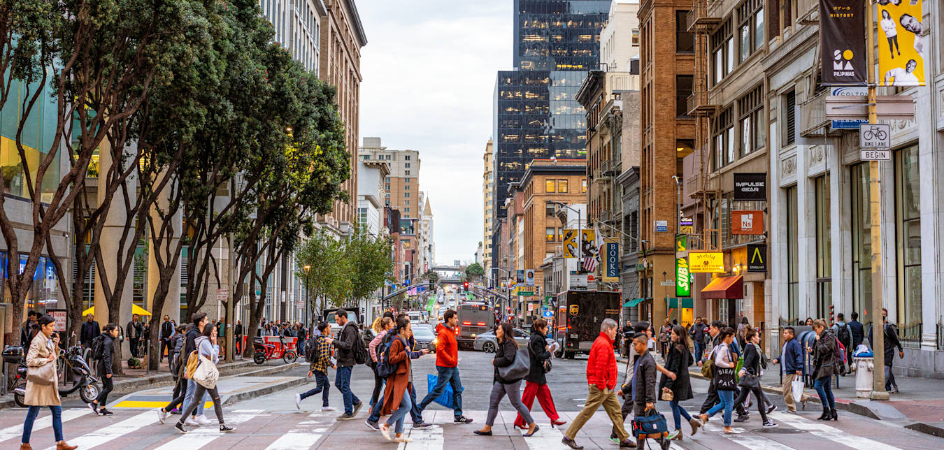 Pedestrians in a busy crosswalk in downtown San Francisco.