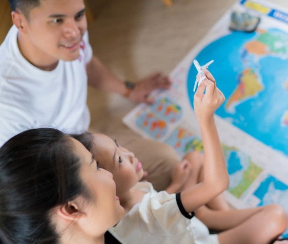 Family planning a vacation in front of a map, picture