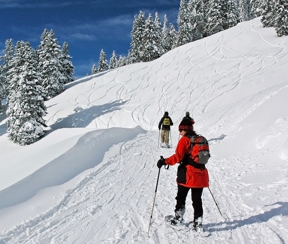 People snowshoe on a trail on Mount Ashland in the snow, image
