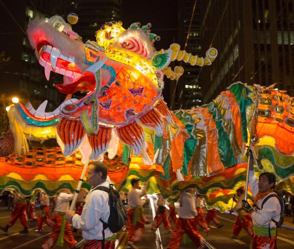 dragon with escorts in Chinese New Year parade at night in San Francisco