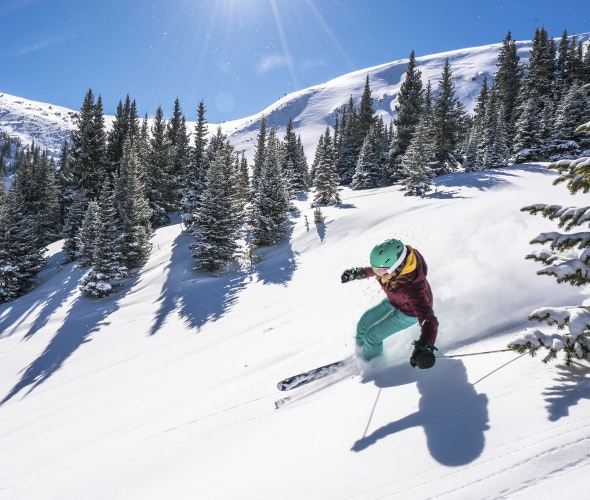 A woman skis down a run at Winter Park Resort in Colorado, photo