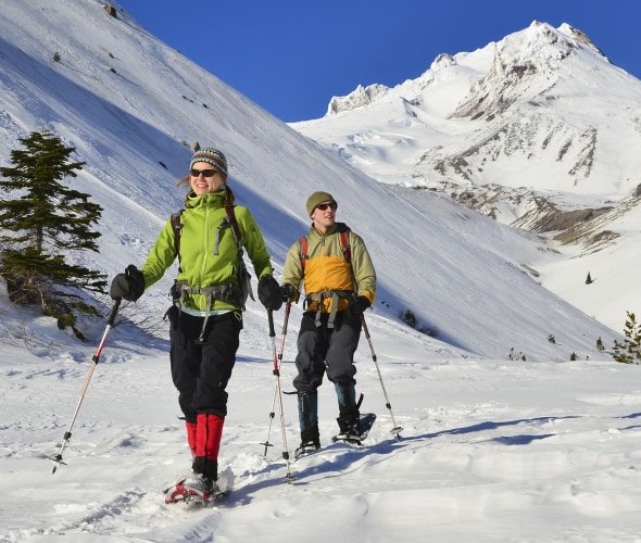 two hikers snow shoe at Mount Hood