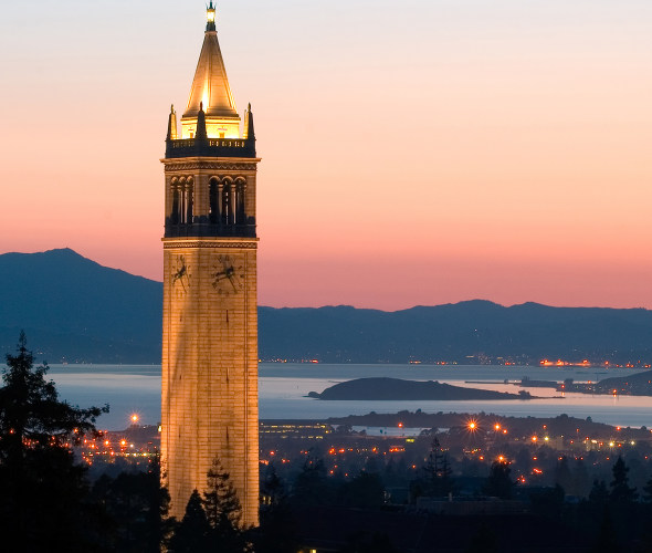Sather Tower rises over the campus and city at sunset at University of California, Berkeley, photo