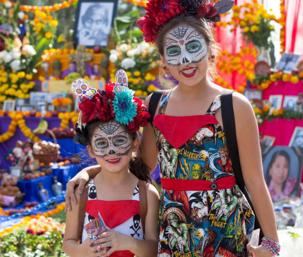 two sisters with decorated faces, image