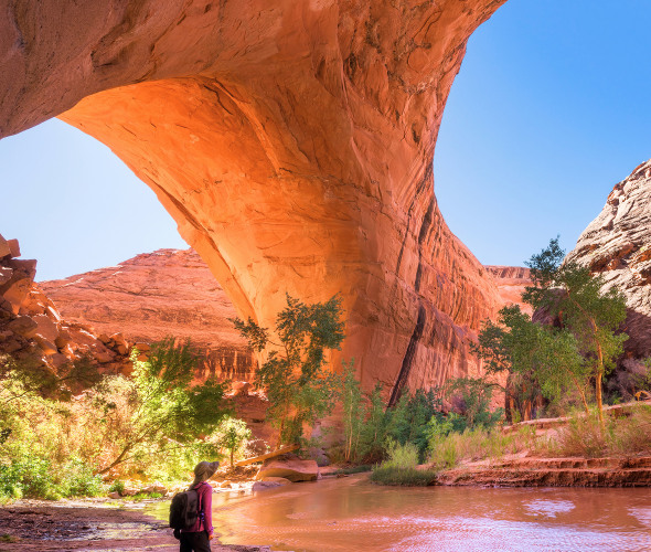 a hiker in Jacob Hamblin Arch in Grand Staircase-Escalante National Monument's Coyote Gulch, picture