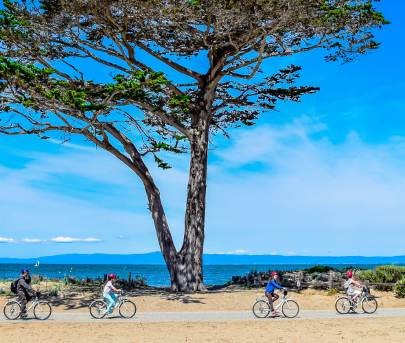 A family rides along the Monterey Bay Coastal Trail in Monterey, California, photo